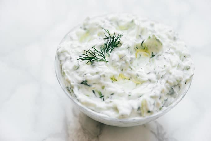Best tzatziki recipe in a bowl on a marble table.
