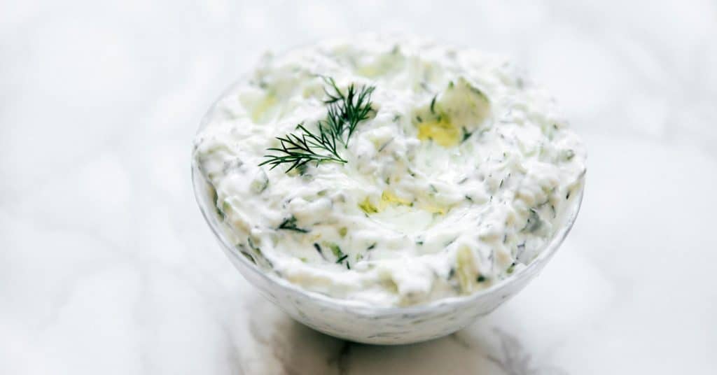 Best tzatziki recipe in a bowl on a marble table.