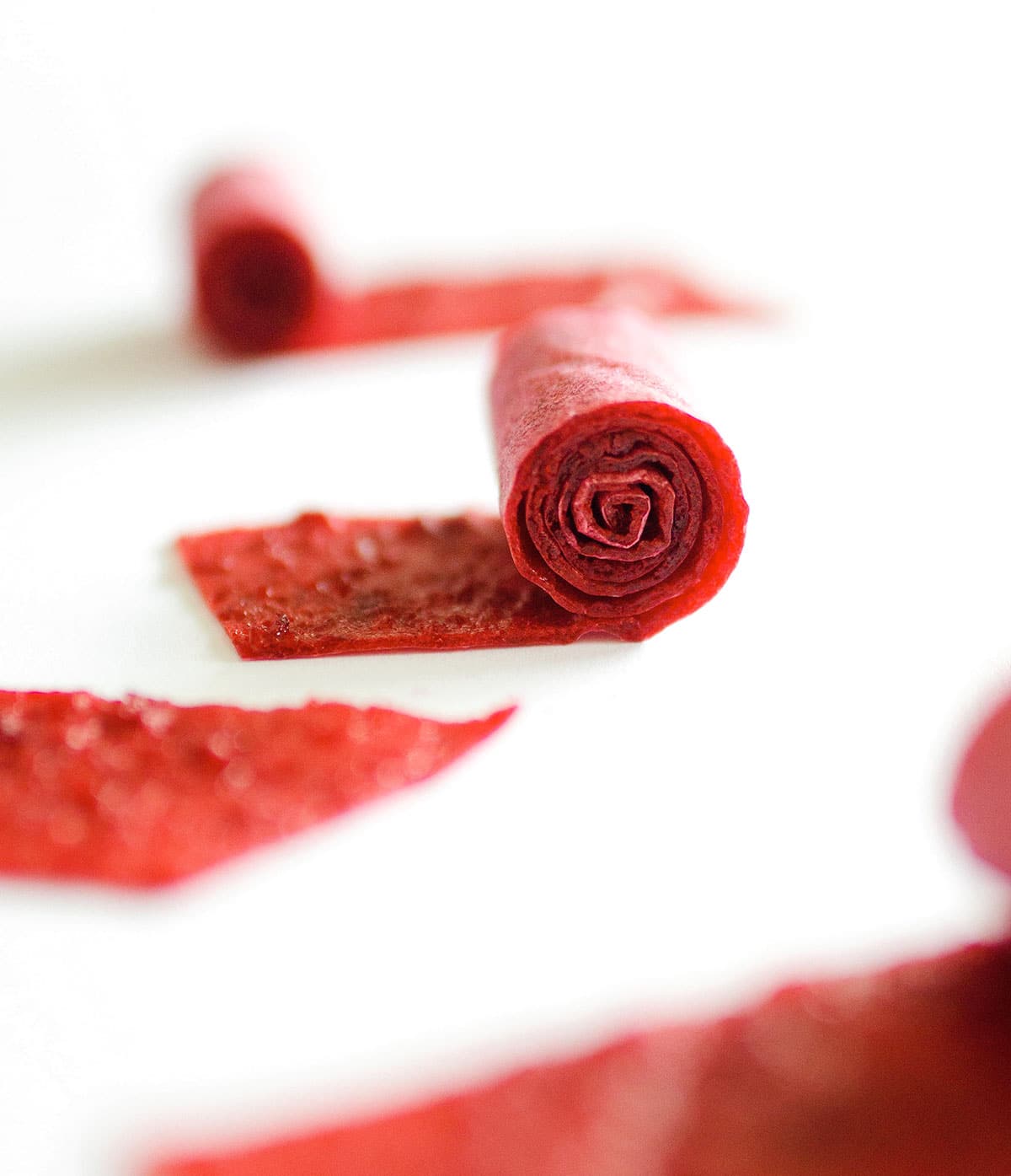 Homemade fruit roll ups on a white background.