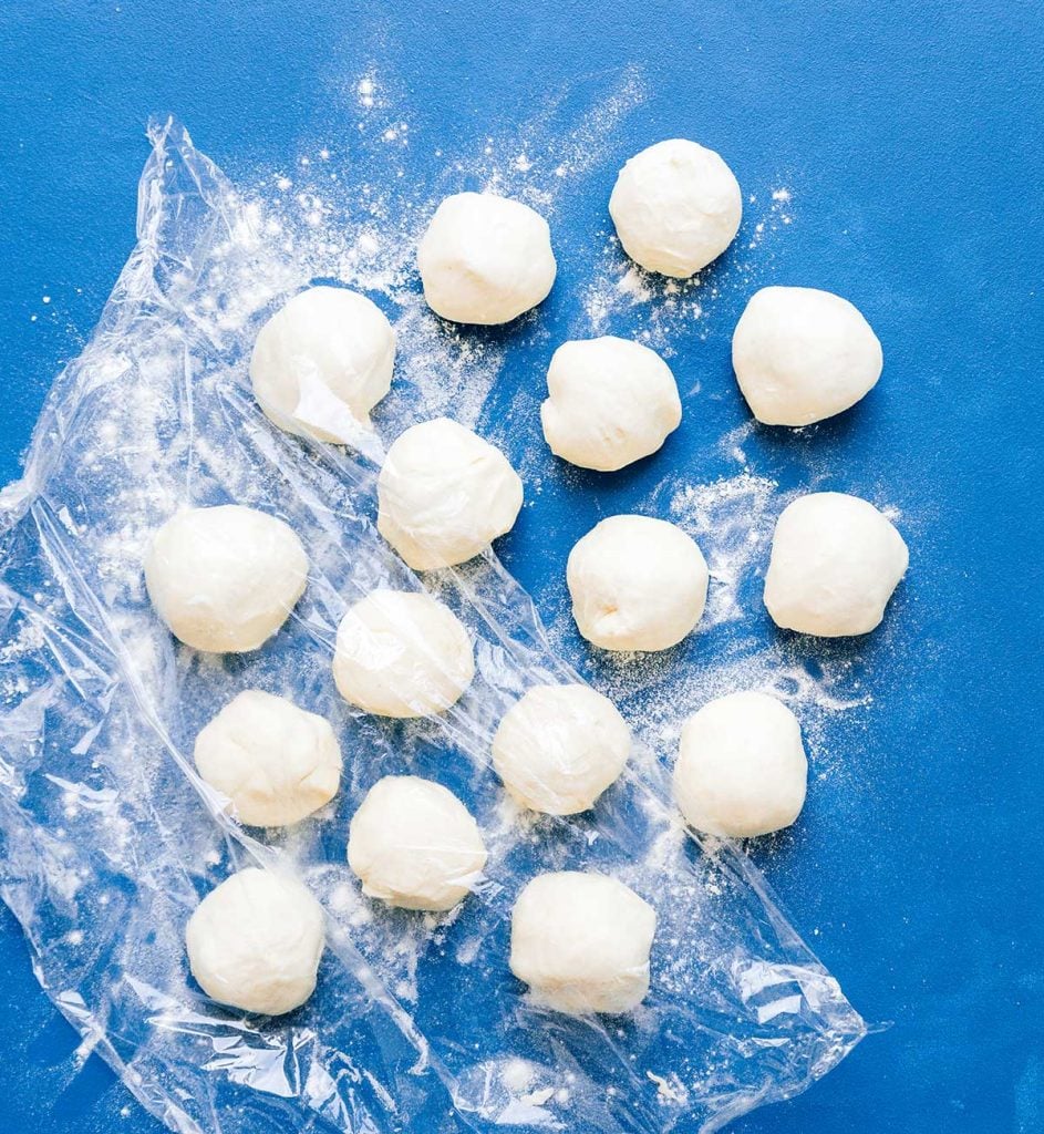 Dough balls for making tortillas on a blue background
