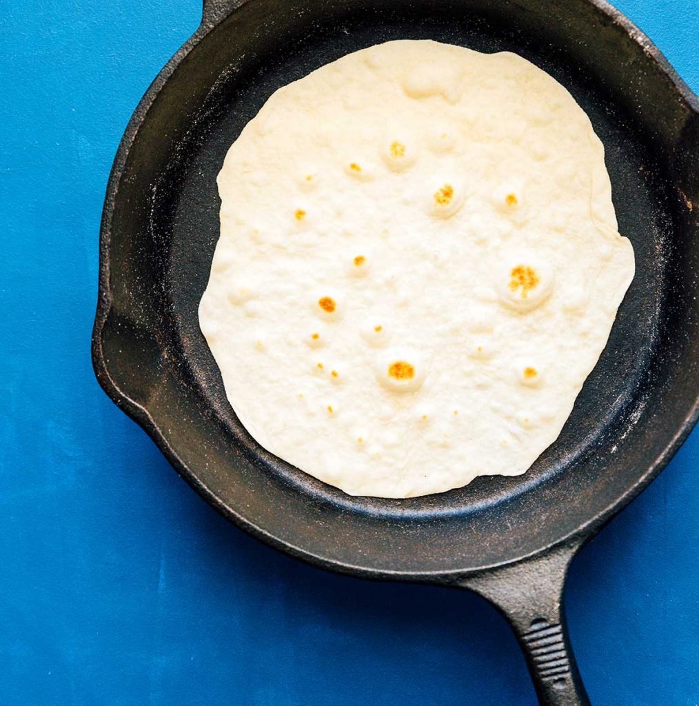 Cooking a flour tortilla in a cast iron skillet
