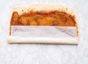 Easy way to roll cinnamon rolls on parchment paper