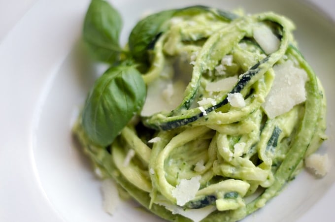 This spiralized zucchini pasta is tossed in creamy basil and avocado pesto to make a deliciously low carb and gluten-free dinner!