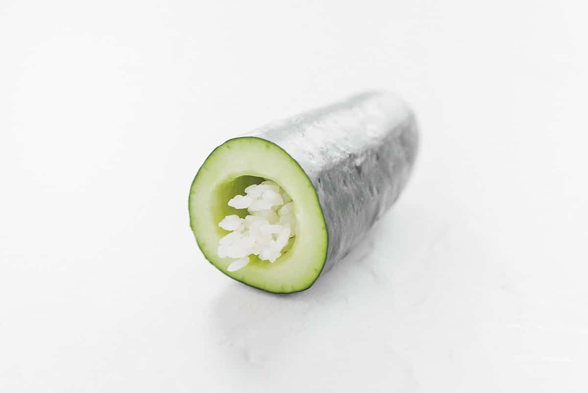 Stuffing a cucumber with rice