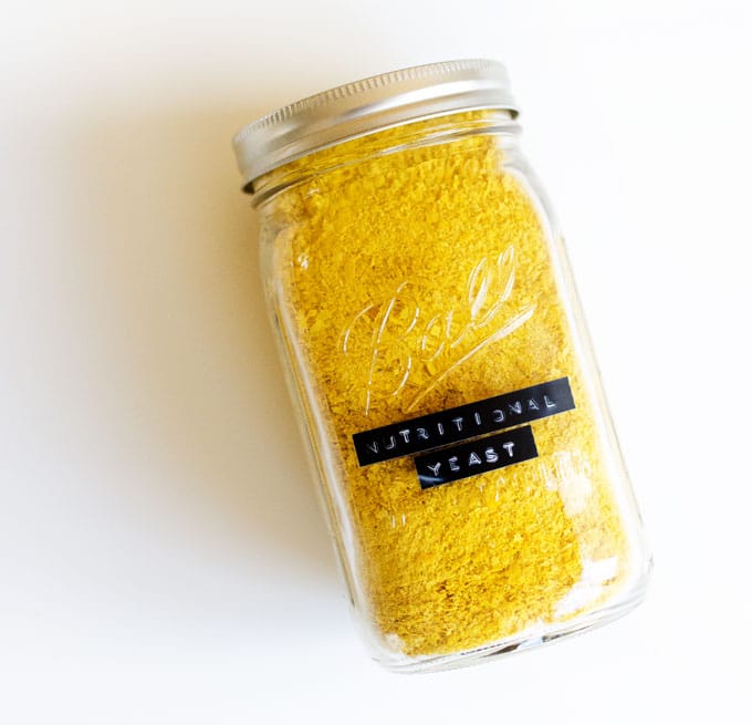 Jar of nutritional yeast on a white background