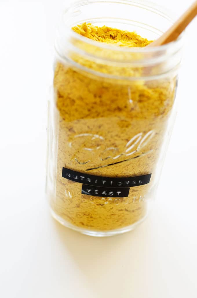 A labelled jar of nutritional yeast on a white background
