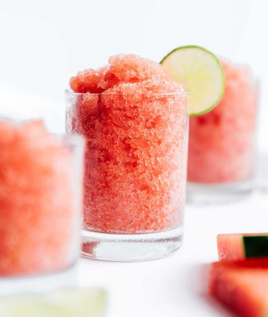 Watermelon granitas in a glass with a lime