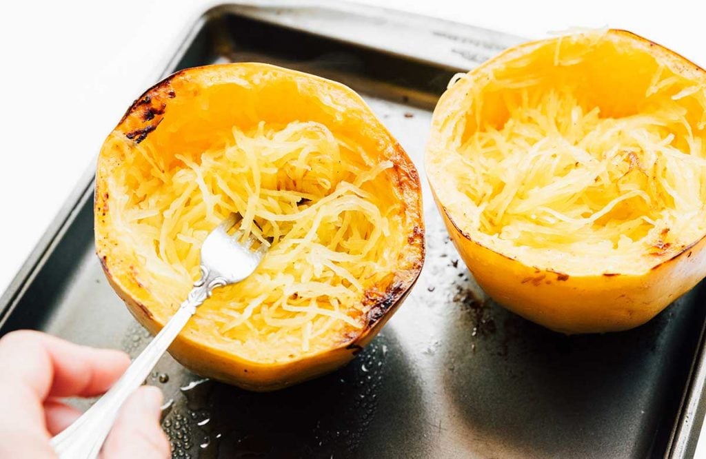 Cooked spaghetti squash on a white background