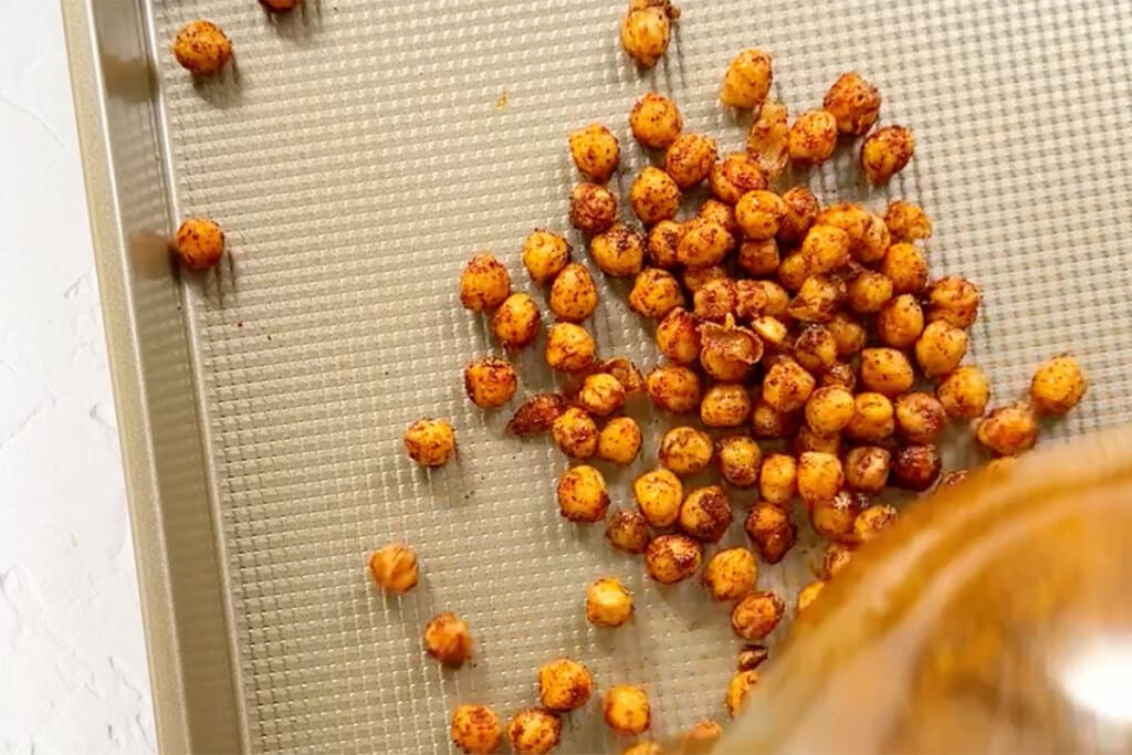 Roasting chickpeas on a tray.