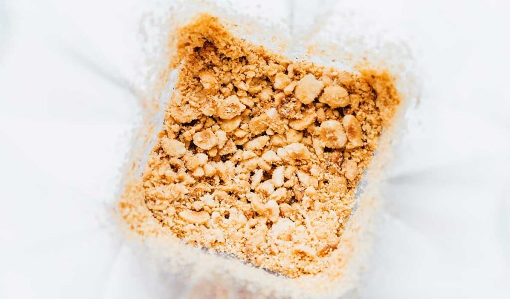 A food processor filled with freshly blended hazelnuts 