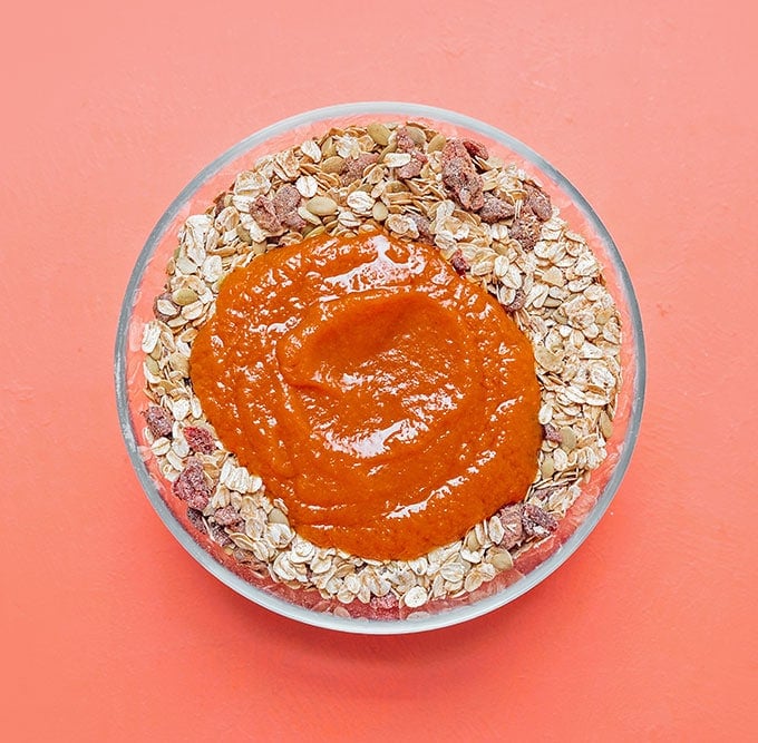 Stirring together pumpkin granola ingredients in a bowl