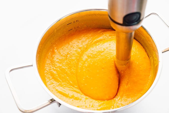 Pureeing pumpkin soup with an immersion blender
