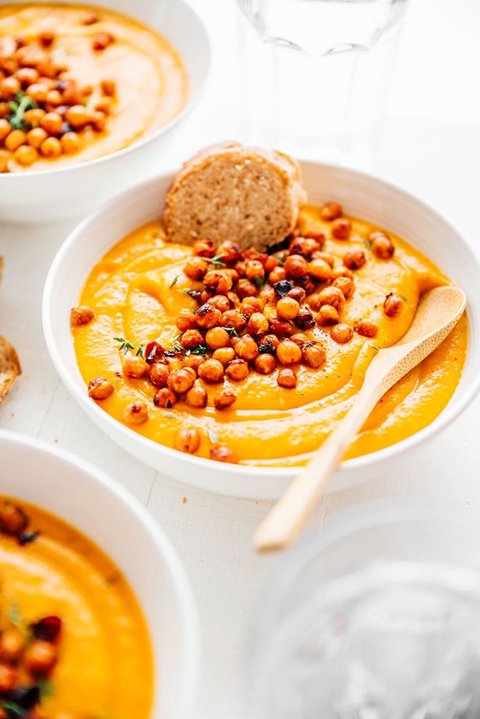 Pumpkin soup in a bowl with chickpeas on top