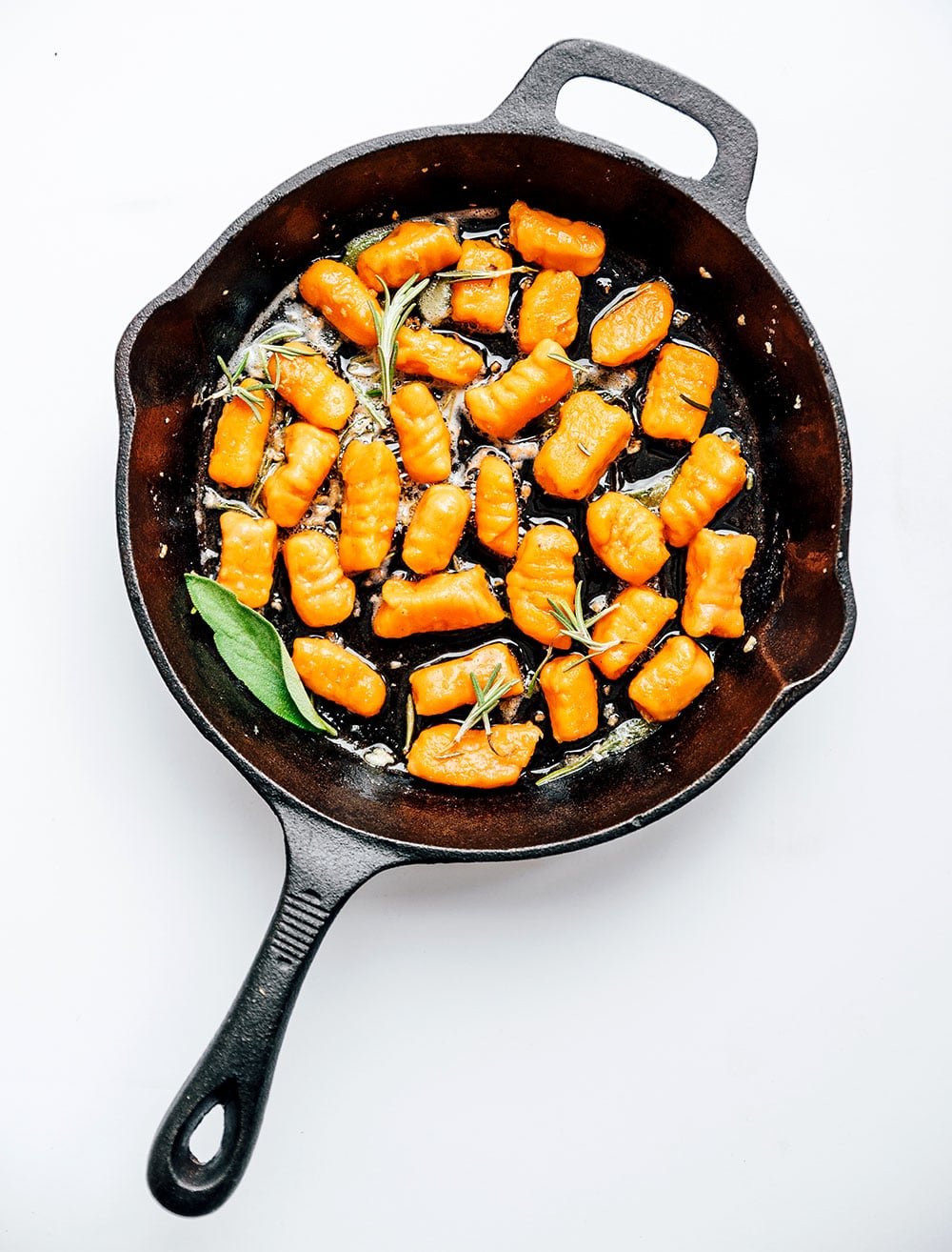 Sweet potato gnocchi in a skilley on a white background