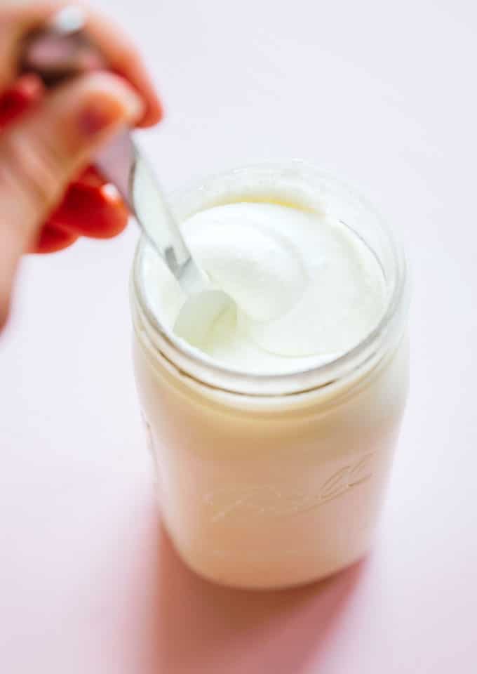 Stirring greek yogurt in a jar