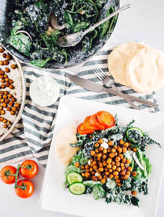 This kale salad is a healthy twist on Greek gyros that's packed with flavorful chickpeas and nutritious greens, and topped with a refreshing cucumber tzatziki sauce.