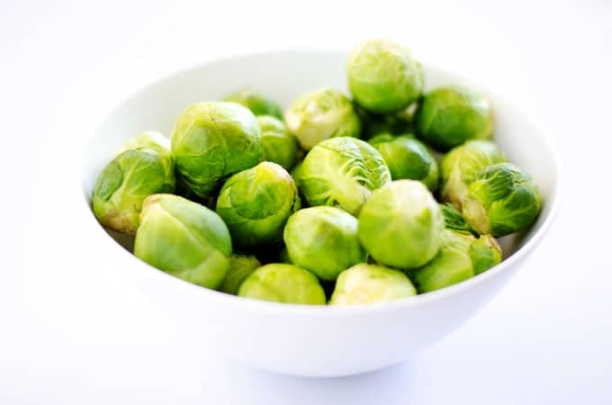 Brussels sprouts in a bowl on white background