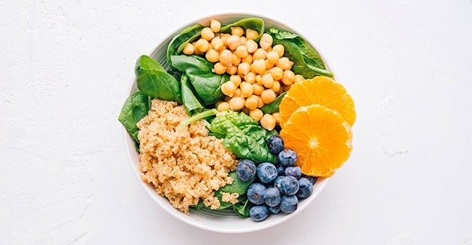 Buddha bowl recipe with fruits and veggies in a bowl