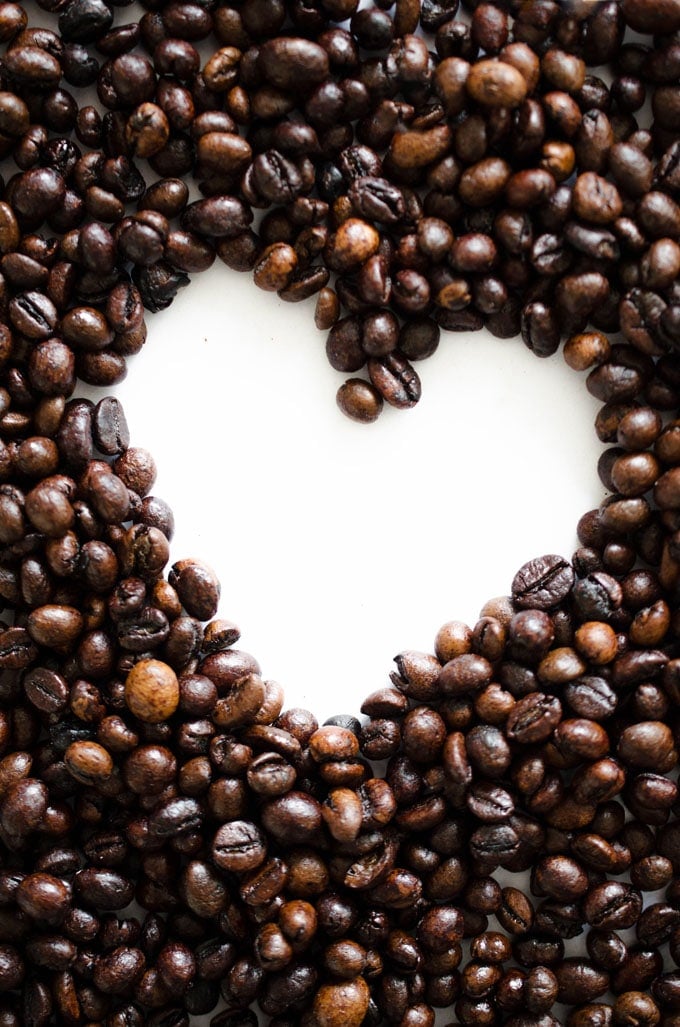Coffee beans forming a heart on a white background