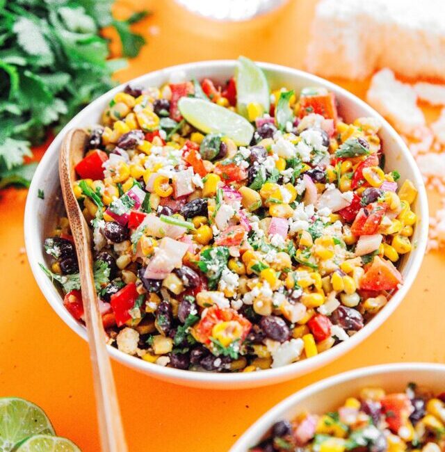 Mexican street corn salad in a white bowl with a spoon