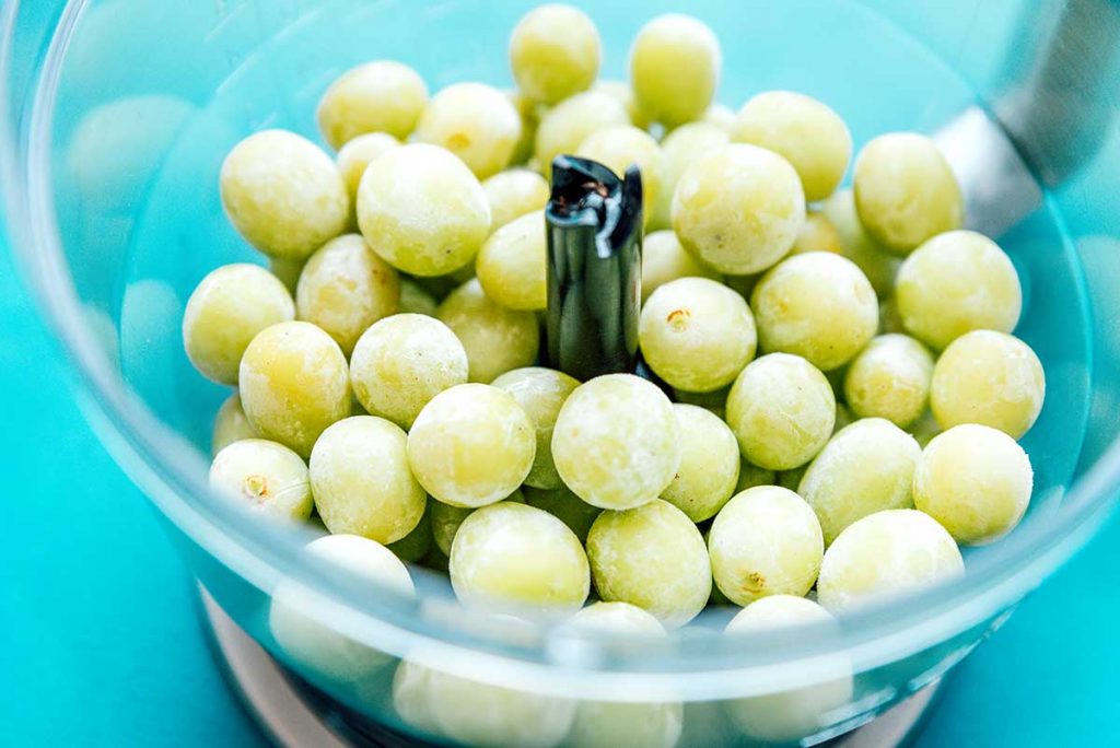 Frozen green grapes in a food processor