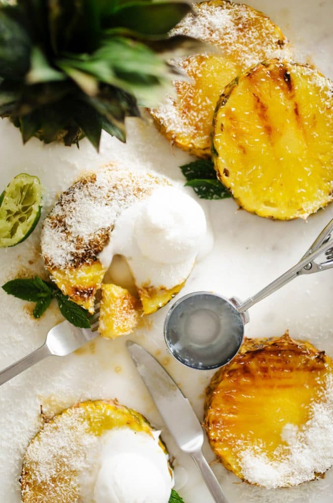 Grilled pineapple with coconut and ice cream on top