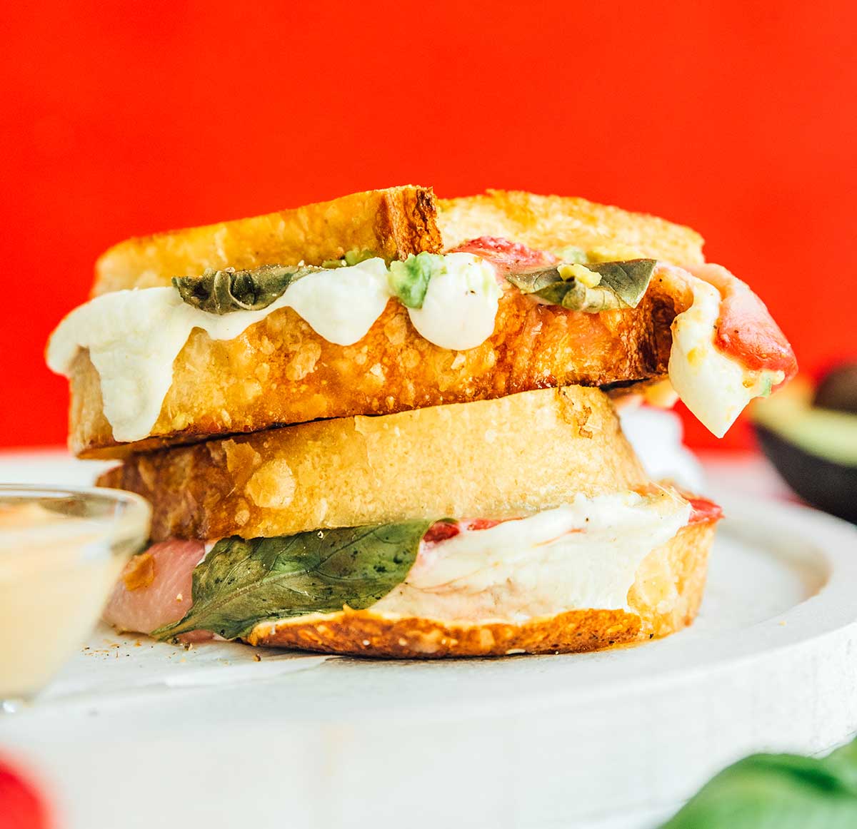 Two halves of a strawberry avocado grilled cheese stacked on top of one another