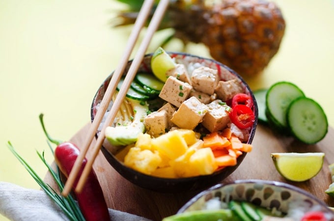 Vegan poke bowls with tofu, pineapple, avocado, and rice in a bowl