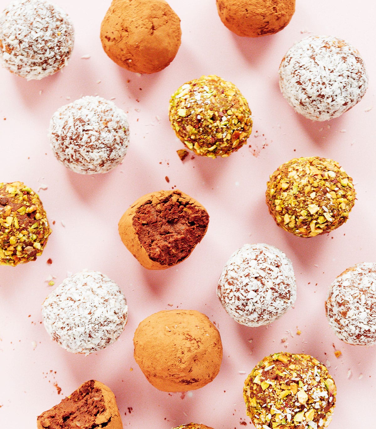 Differently colored truffles on a pink background