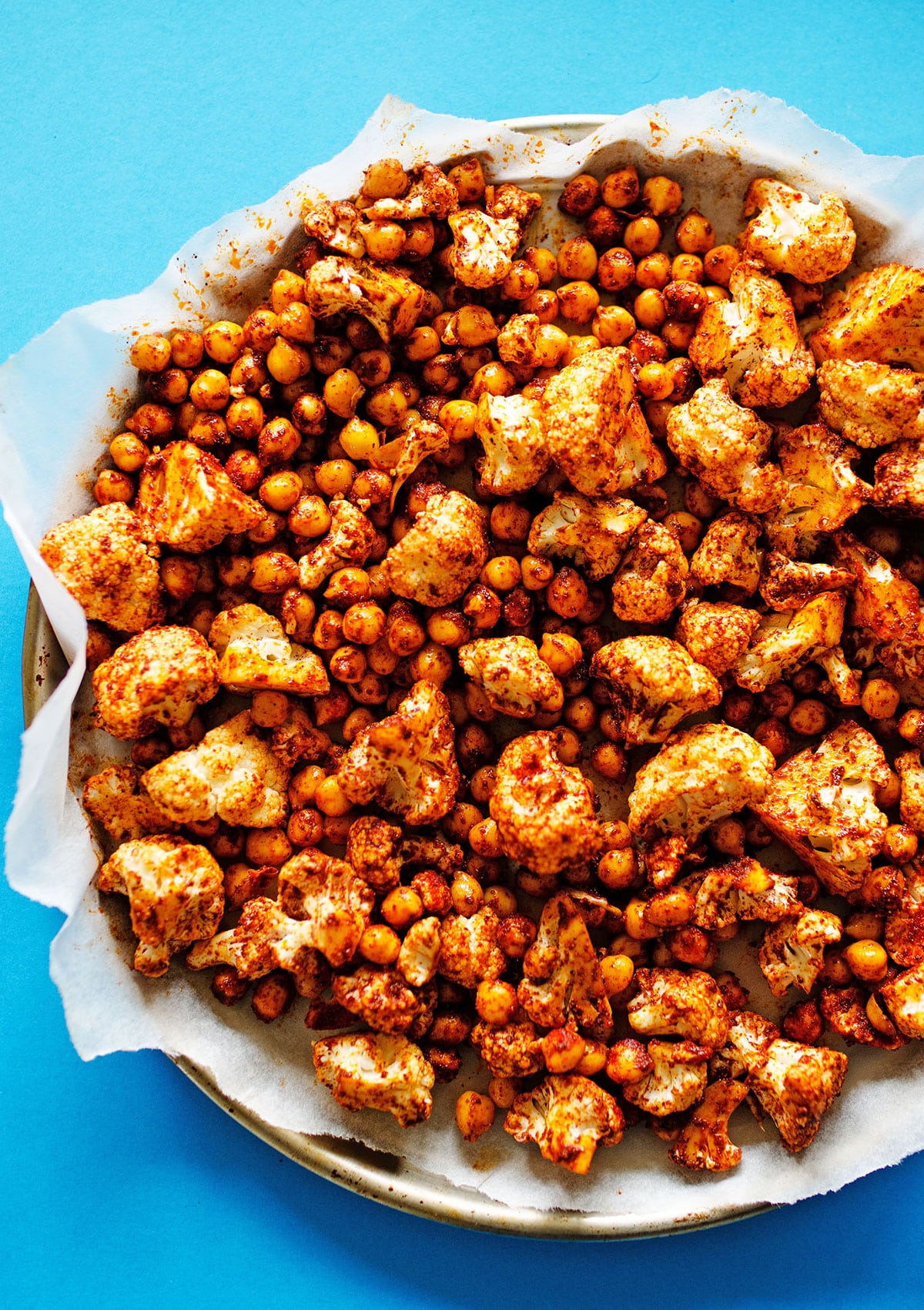 Spiced chickpeas and cauliflower on a baking sheet.