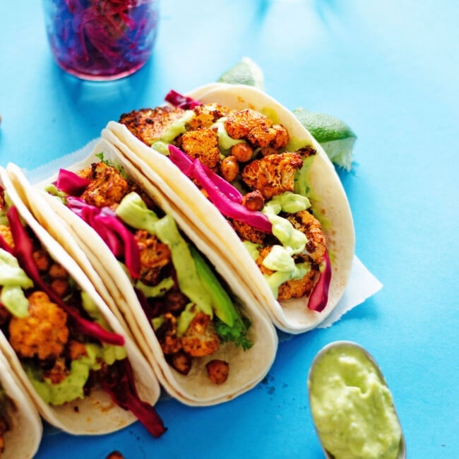 Chickpea cauliflower tacos on a blue background.