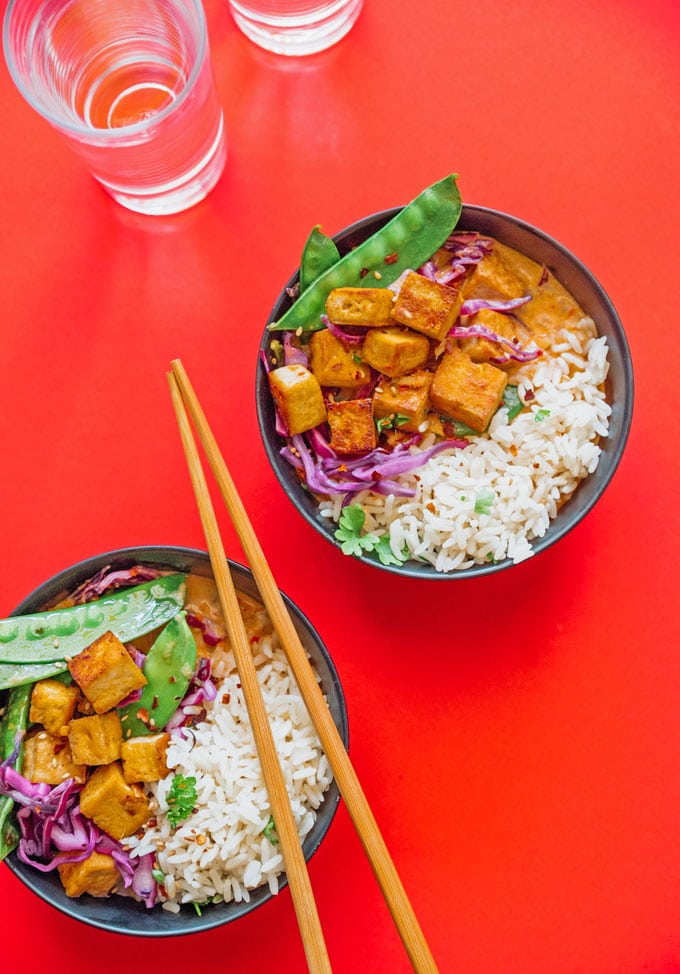 Vegan Thai red curry in a bowl on a red background