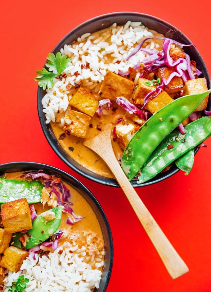 Vegan Thai red curry in a bowl on a red background
