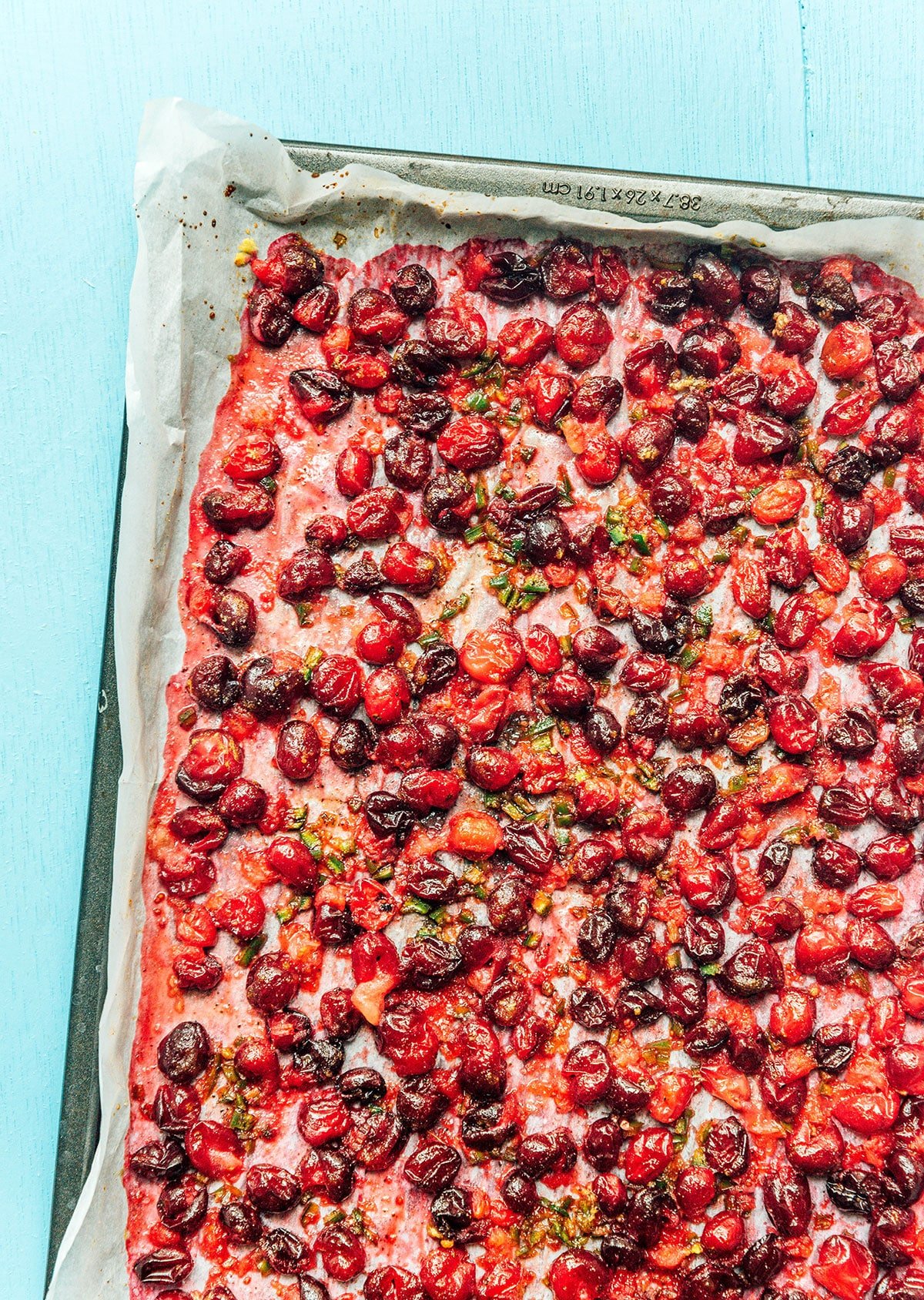 A baking sheet filled with roasted cranberries