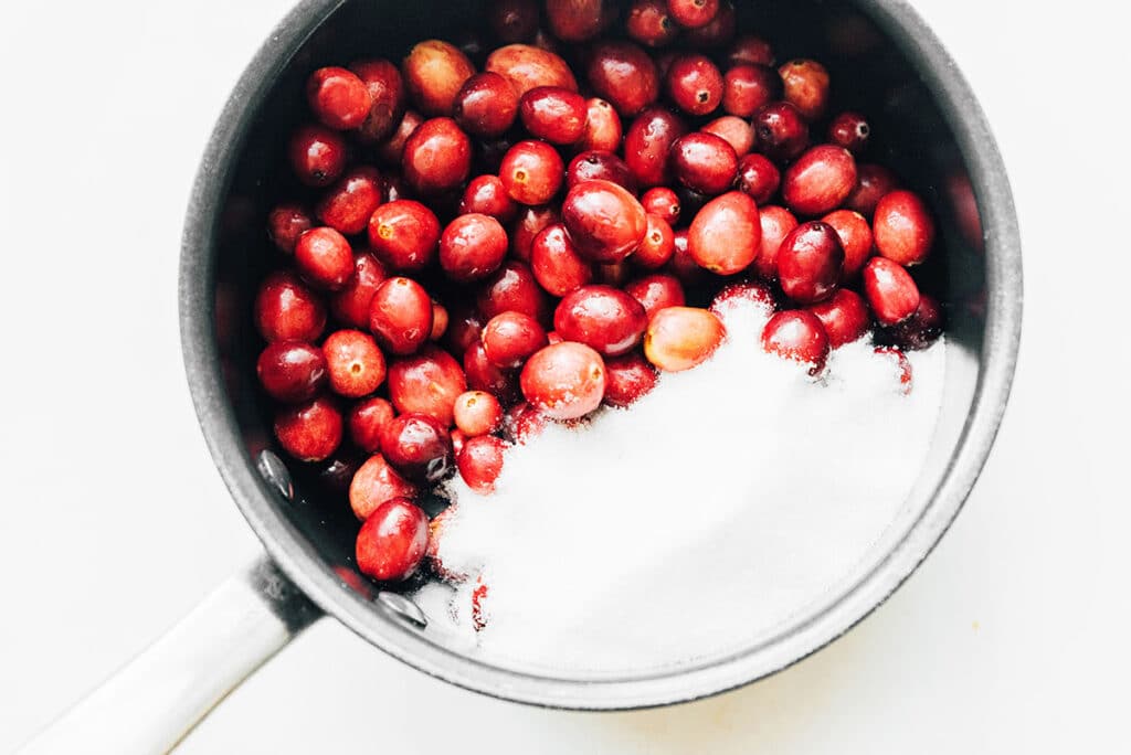 A pot filled with cranberries and sugar