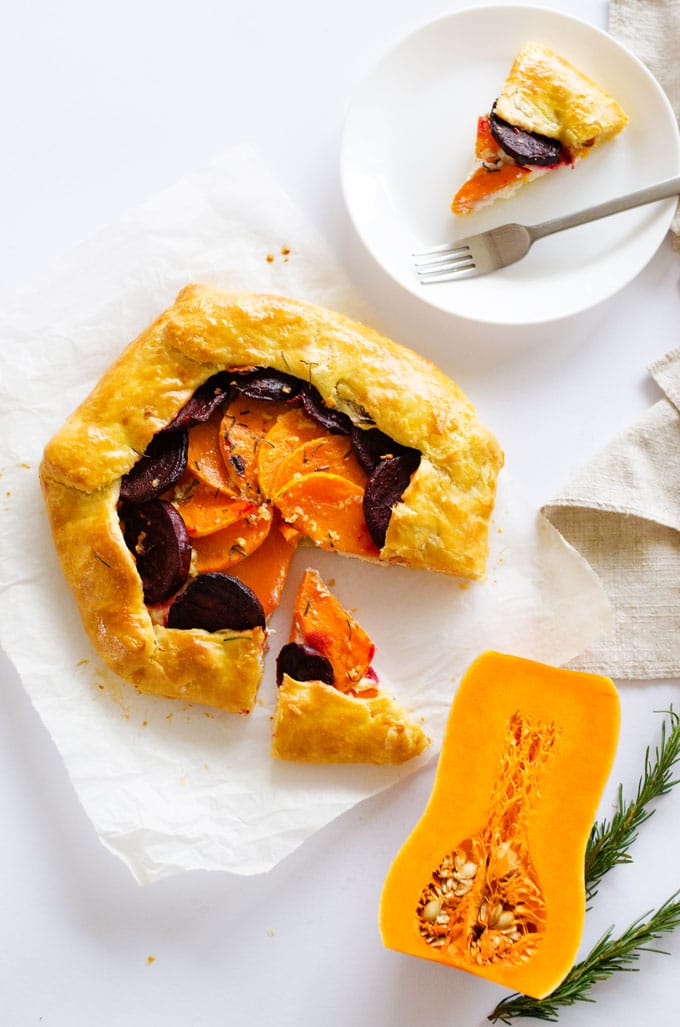 This Butternut Beet and Ricotta Savory Galette is layered with winter veggies and cheese, wrapped up in a flaky golden crust and sprinkled with rosemary.