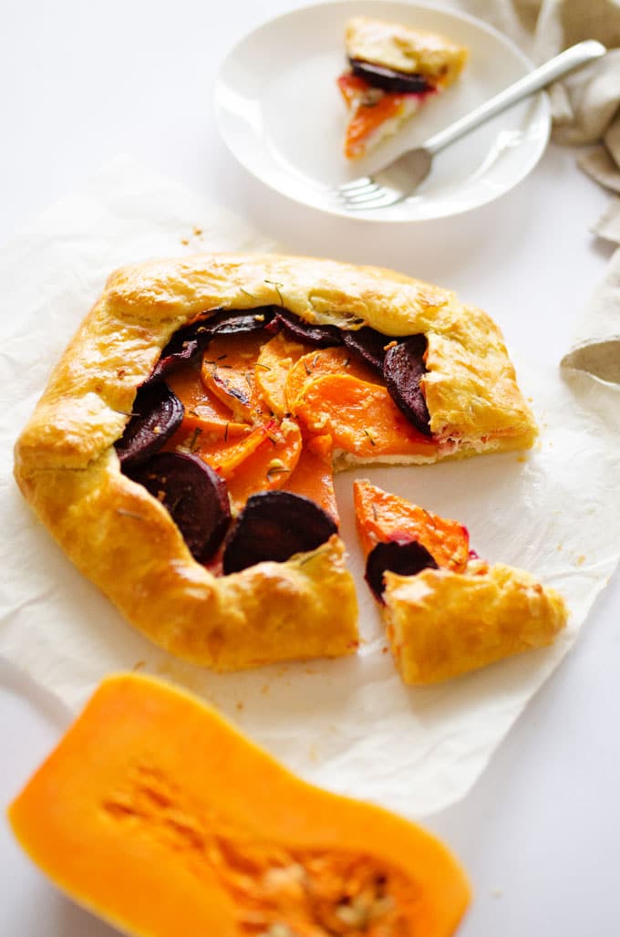 This Butternut Beet and Ricotta Savory Galette is layered with winter veggies and cheese, wrapped up in a flaky golden crust and sprinkled with rosemary.