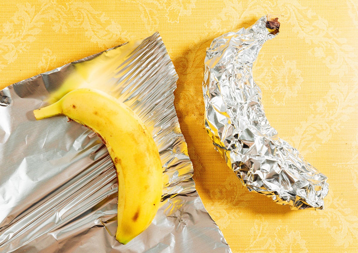 Wrapping a banana in foil.