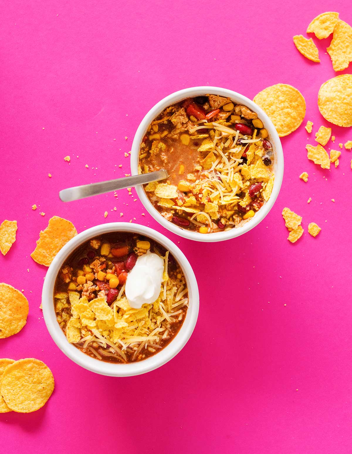 Taco soup in a bowl on a pink background