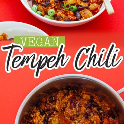 Vegan tempeh chili in white bowls on a red background