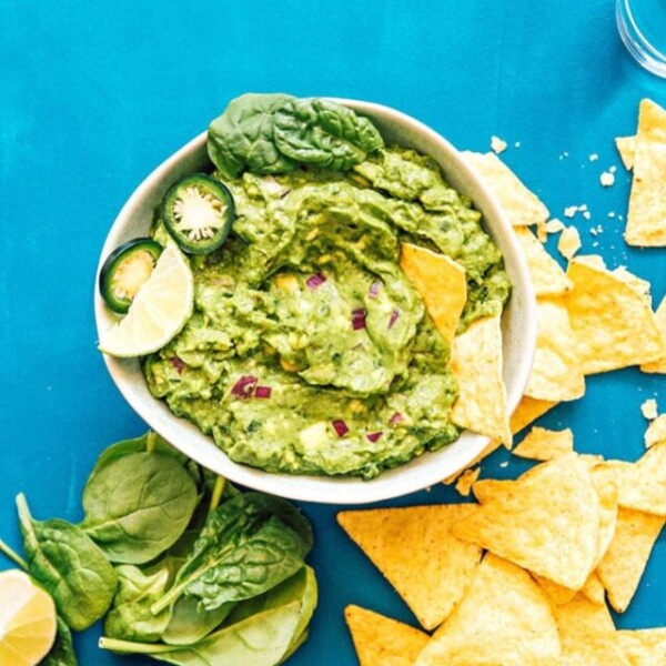 Healthy guacamole in a bowl with spinach