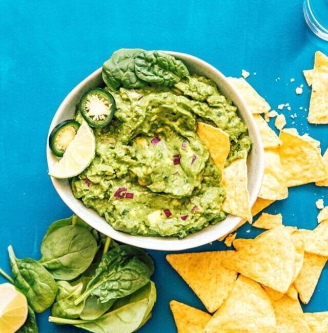Healthy guacamole in a bowl with spinach