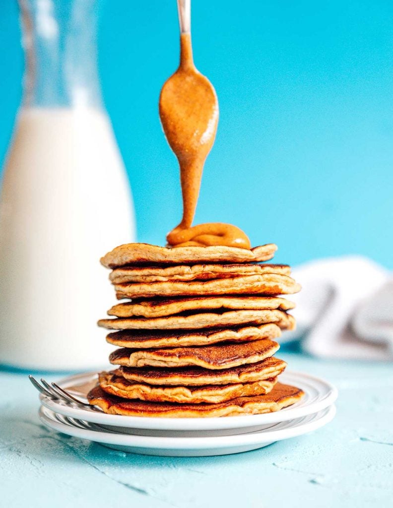 Paleo pancakes with almond butter on a blue background