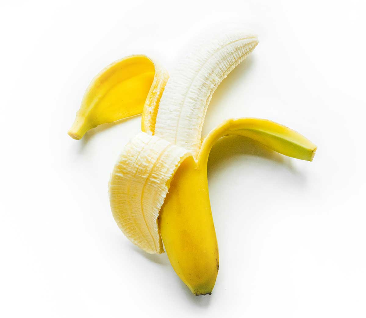 A banana being peeled open on a white background.
