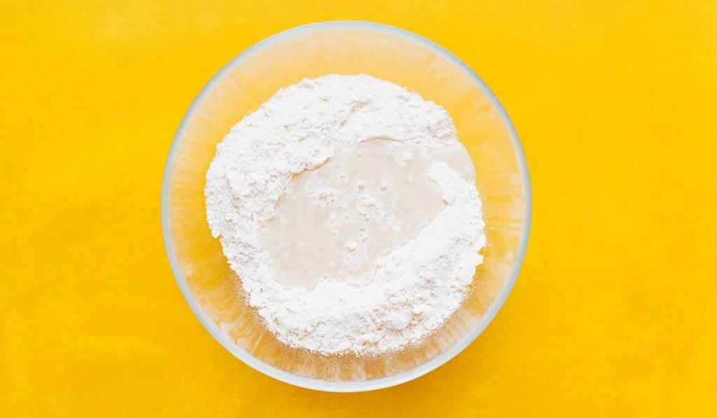 Roasted garlic in bowl of flour