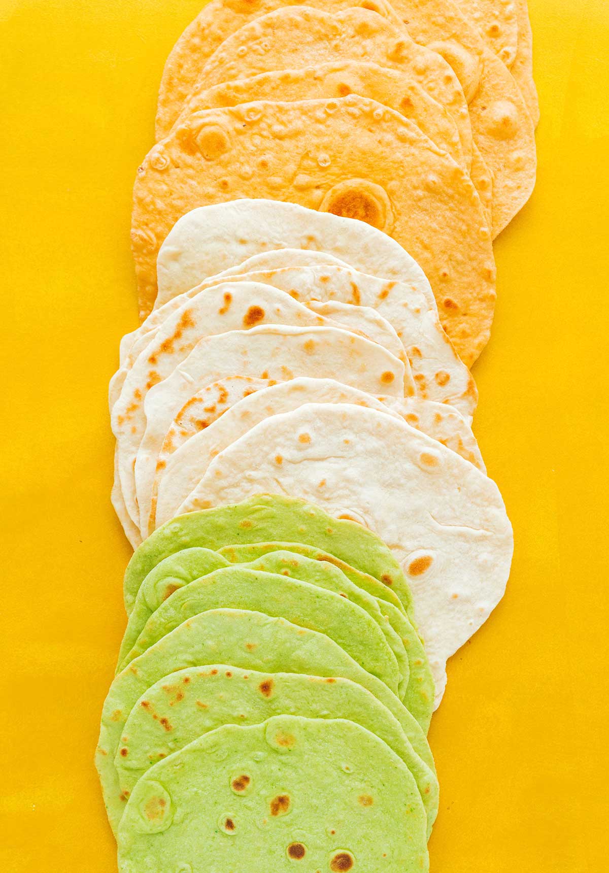 Red, white, and green tortillas stacked in a row
