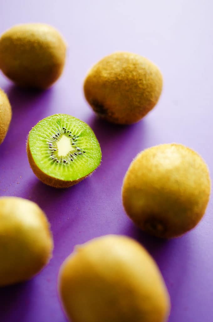 Picture of a kiwi on a purple background