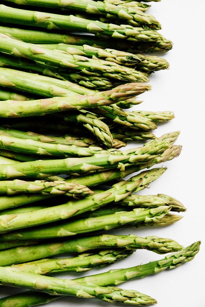 Green asparagus stalks on a white background
