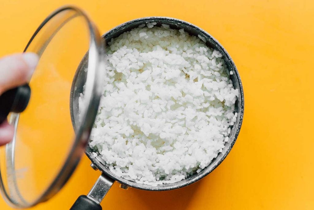 A pot filled with cooked white fluffy rice