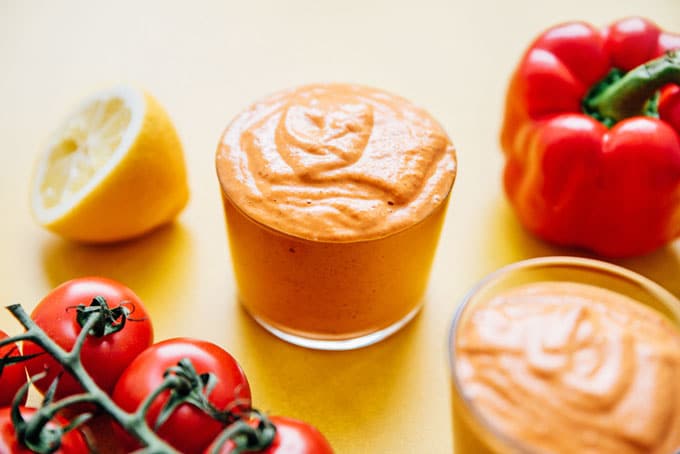 Romesco sauce recipe in a jar with tomatoes and red bell pepper